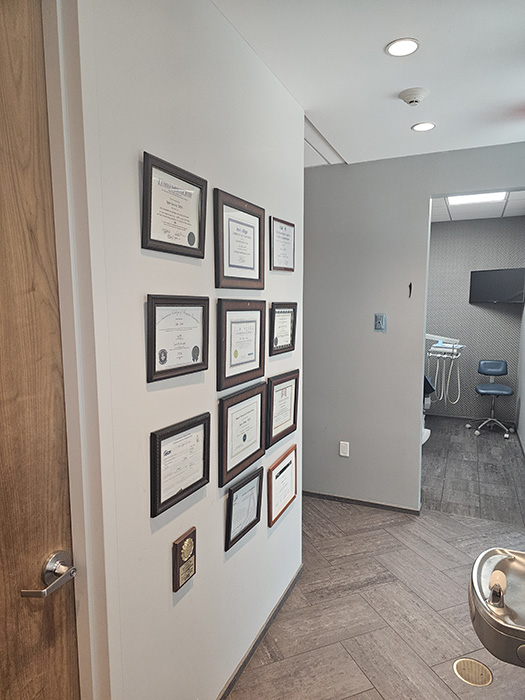 Dentists certifications mounted on wall
